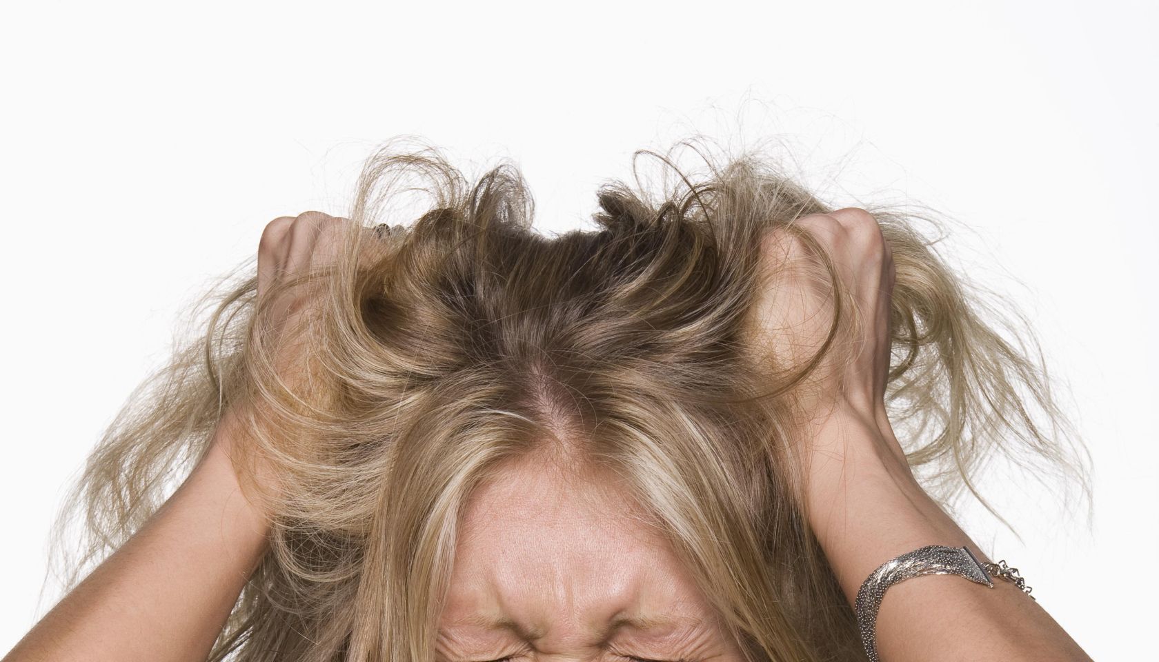 Woman pulling her hair and screaming