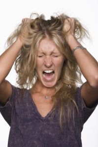 Woman pulling her hair and screaming