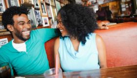 Smiling couple sitting in diner booth
