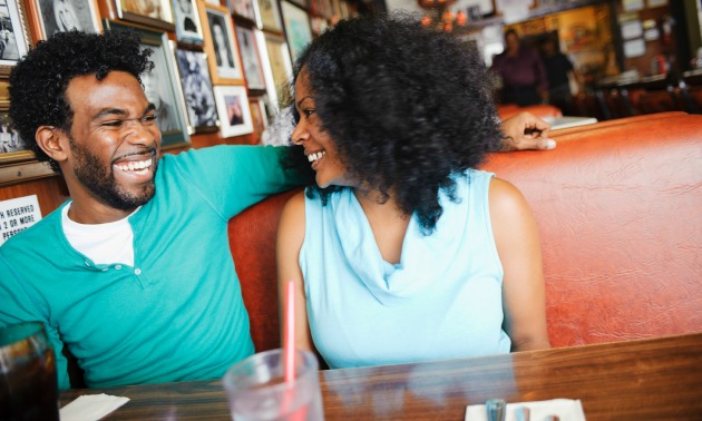 Smiling couple sitting in diner booth