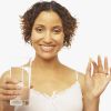 Mixed Race woman holding vitamin