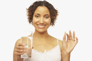 Mixed Race woman holding vitamin