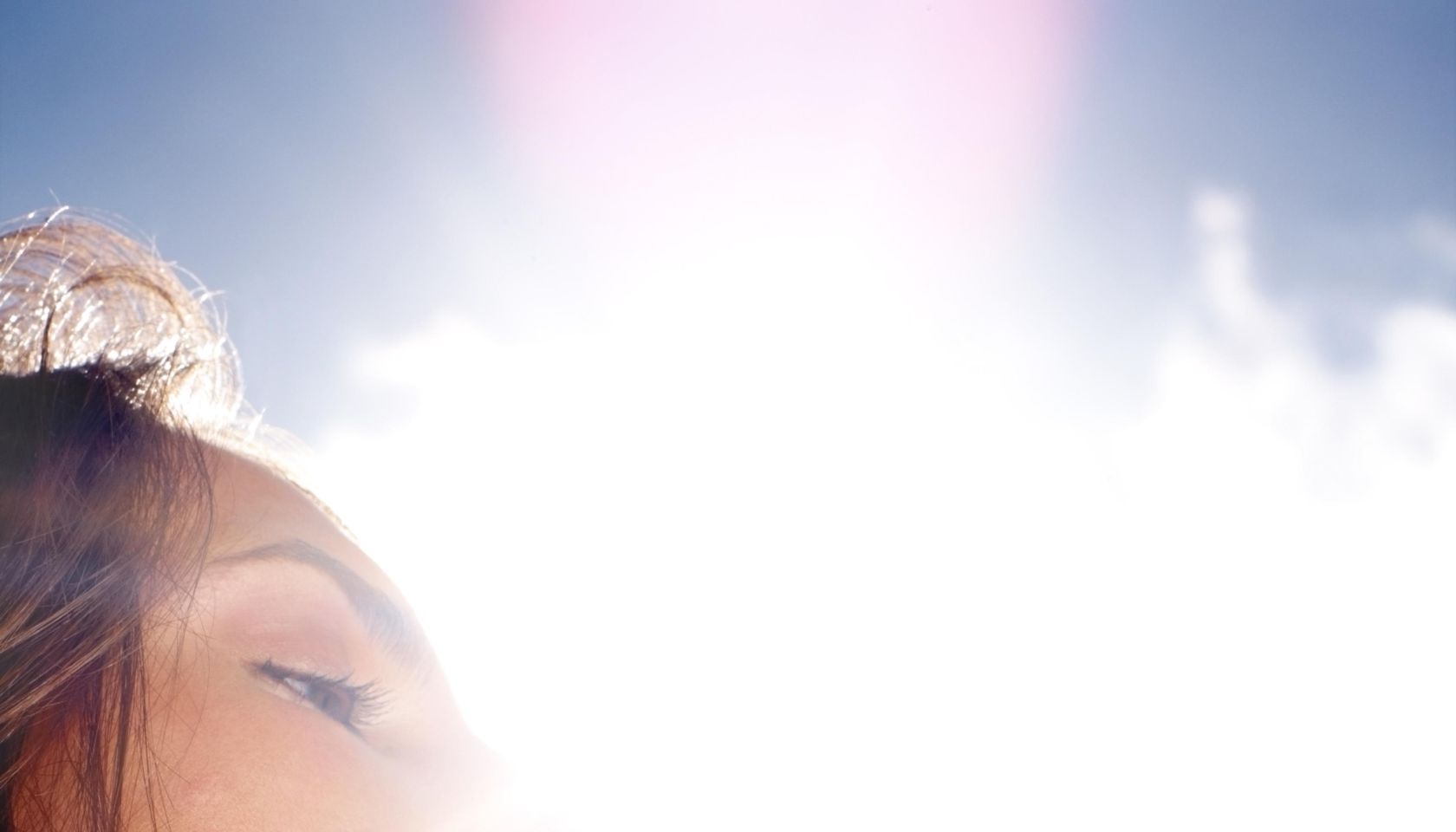 Thirsty woman drinking water on a sunny day