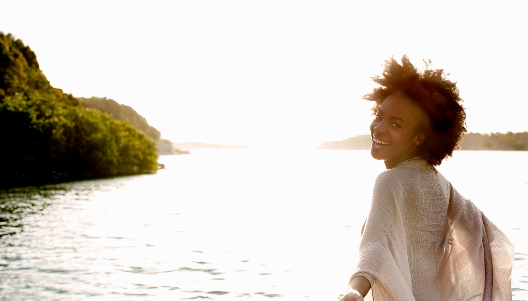 Happy young woman looking back and laughing.