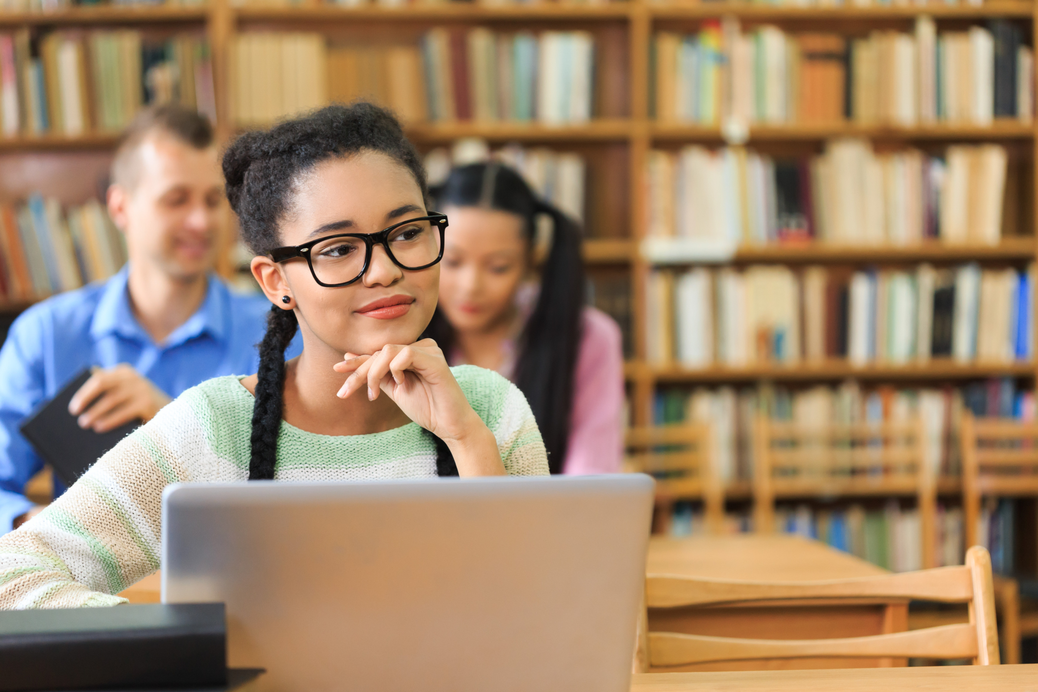 Attractive young woman at the library- chin on hand
