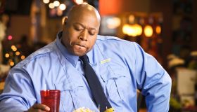 Black police officer eating unhealthy food