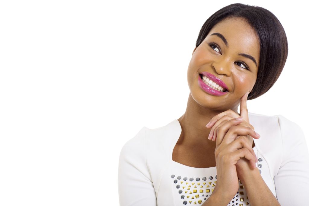 thoughtful african american woman smiling on white background