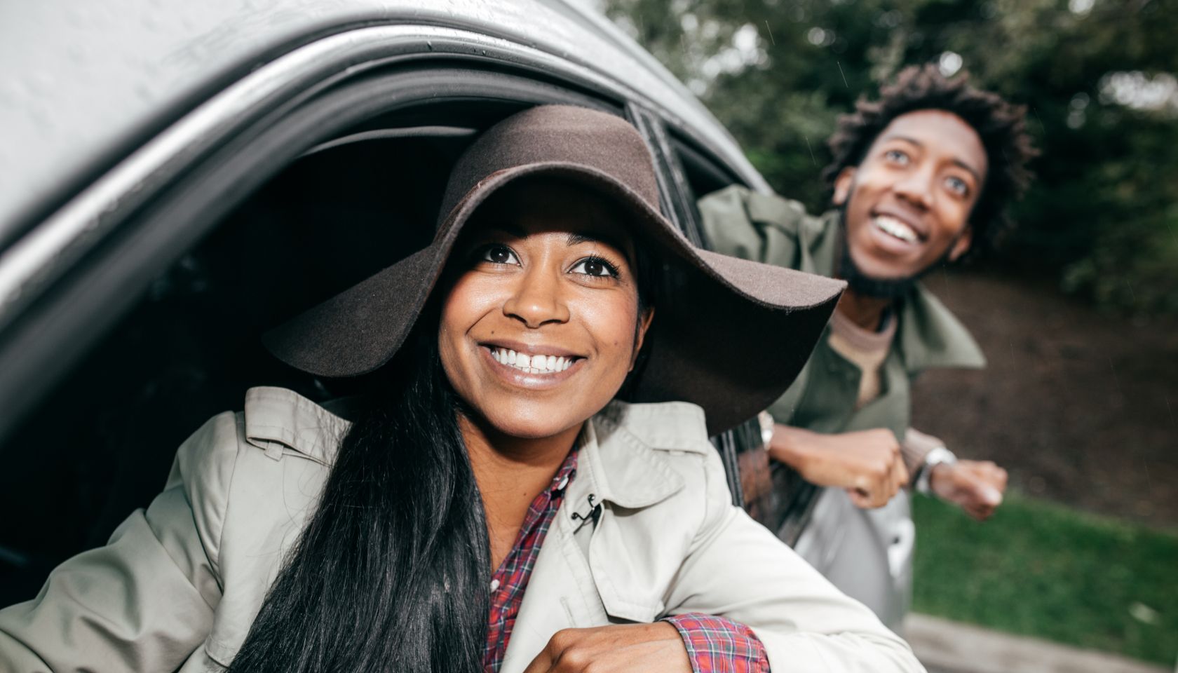 Happy couple with good car insurance