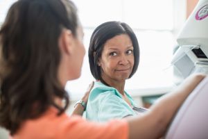 Nurse preparing patient for mammography