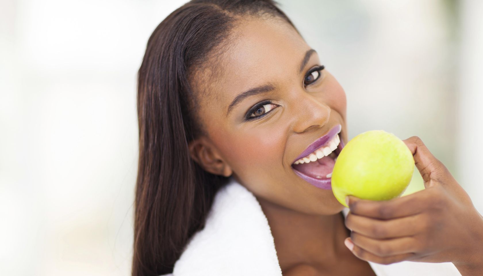 healthy african woman eating apple