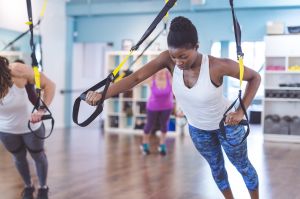 Group of Women Doing Barre + TRX Workout