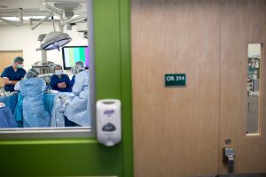 A student and staff watch over a donor d