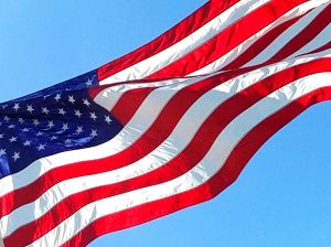 Low Angle View Of American Flag Against Clear Blue Sky