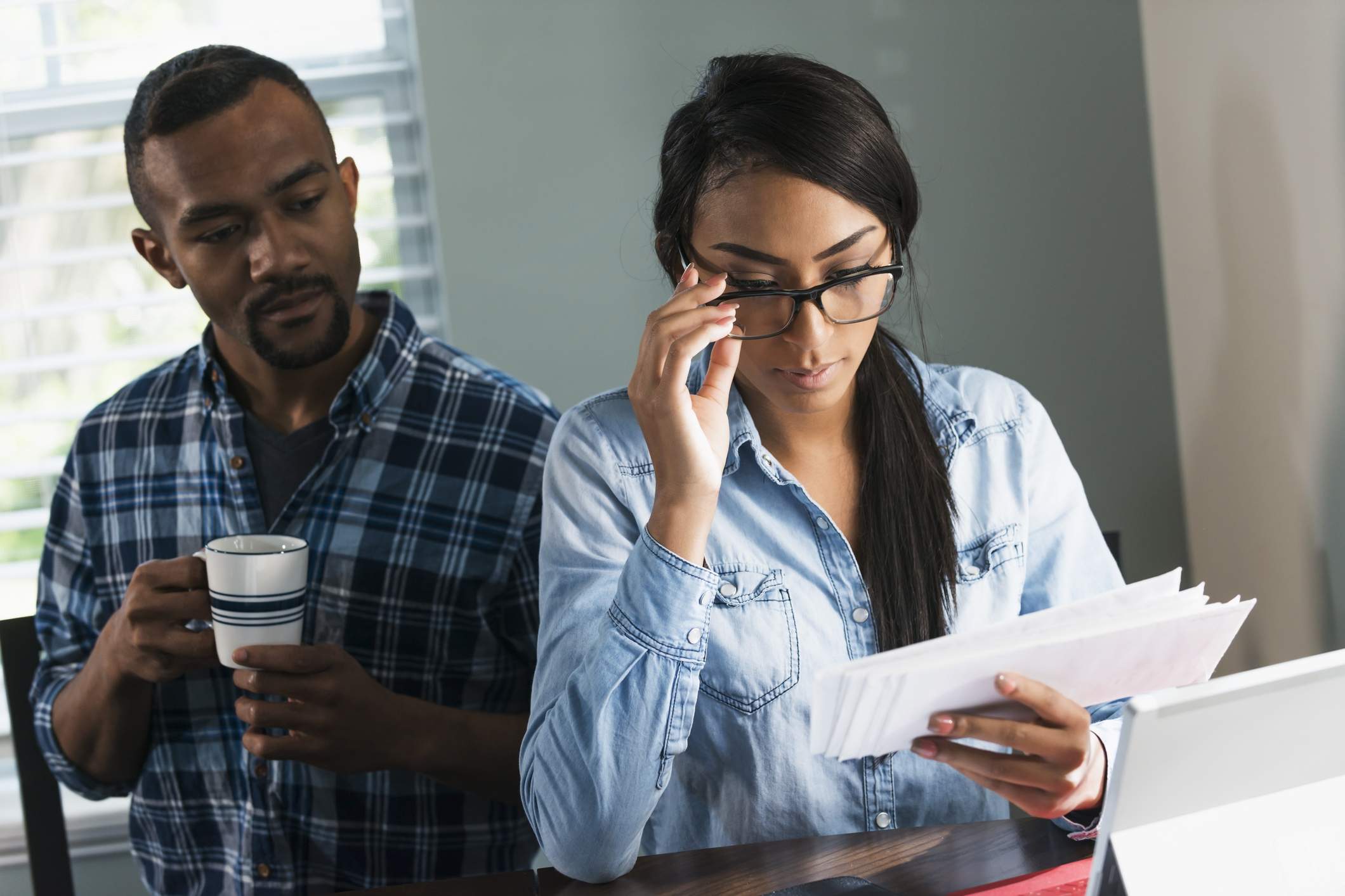 Young black couple paying bills on computer