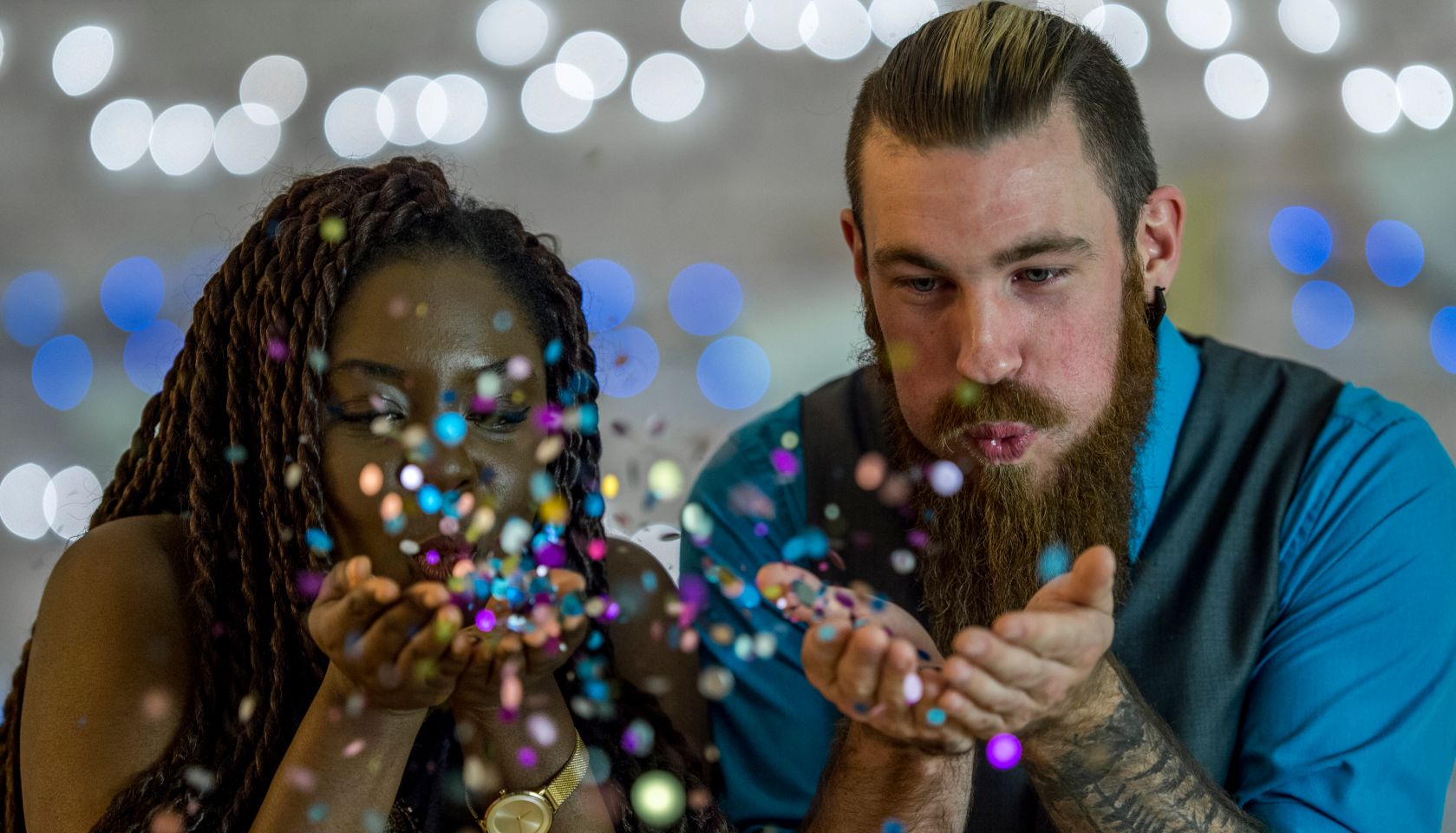 Couple Blowing Glitter Out of Their Hands