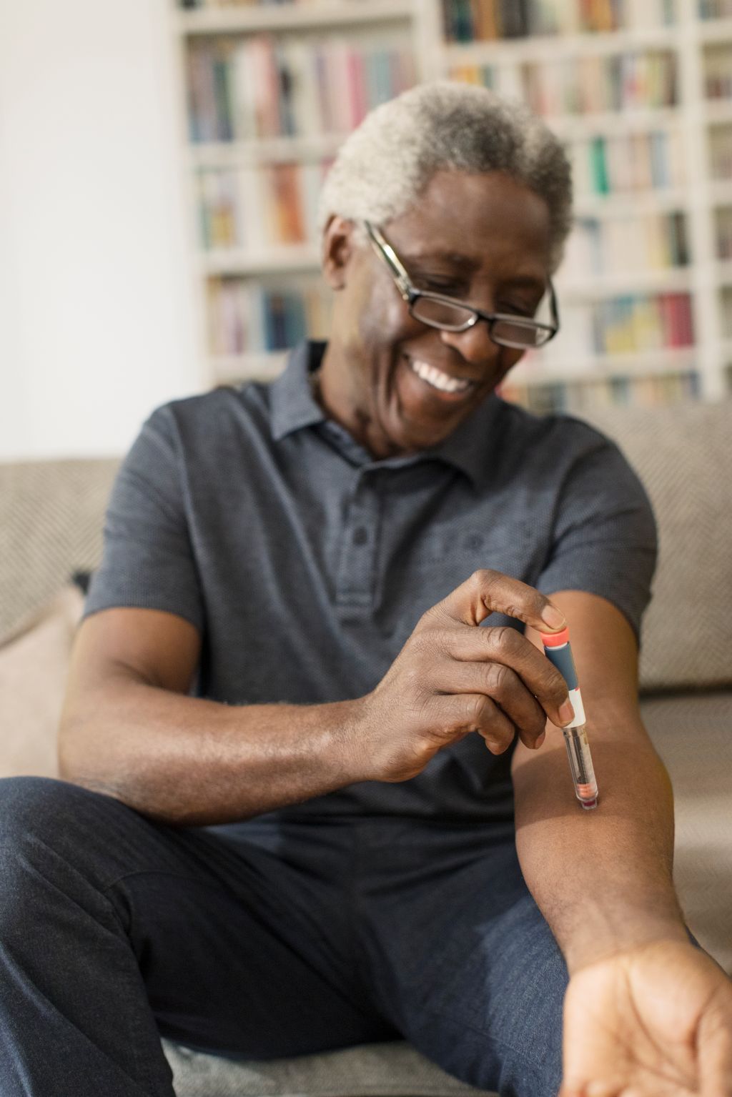Smiling senior man taking insulin