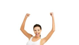 Portrait Of Young Woman Flexing Muscles While Standing On Weight Scale Against White Background