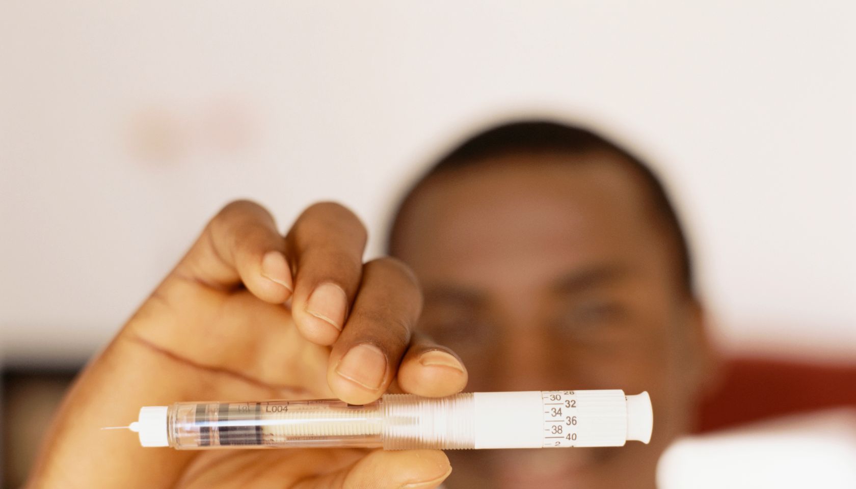 Young man holding a syringe
