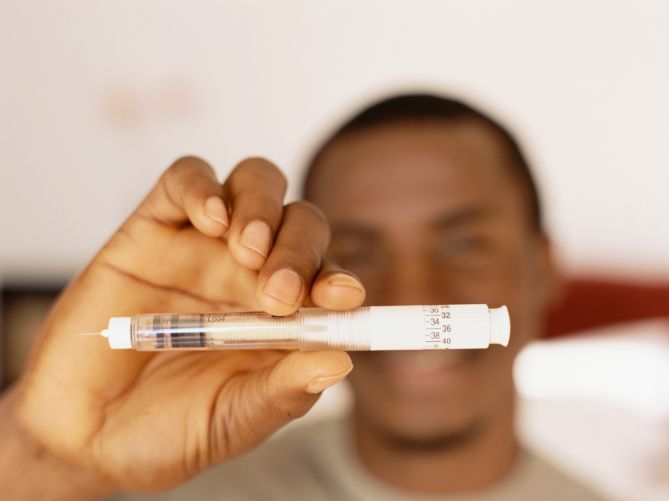 Young man holding a syringe