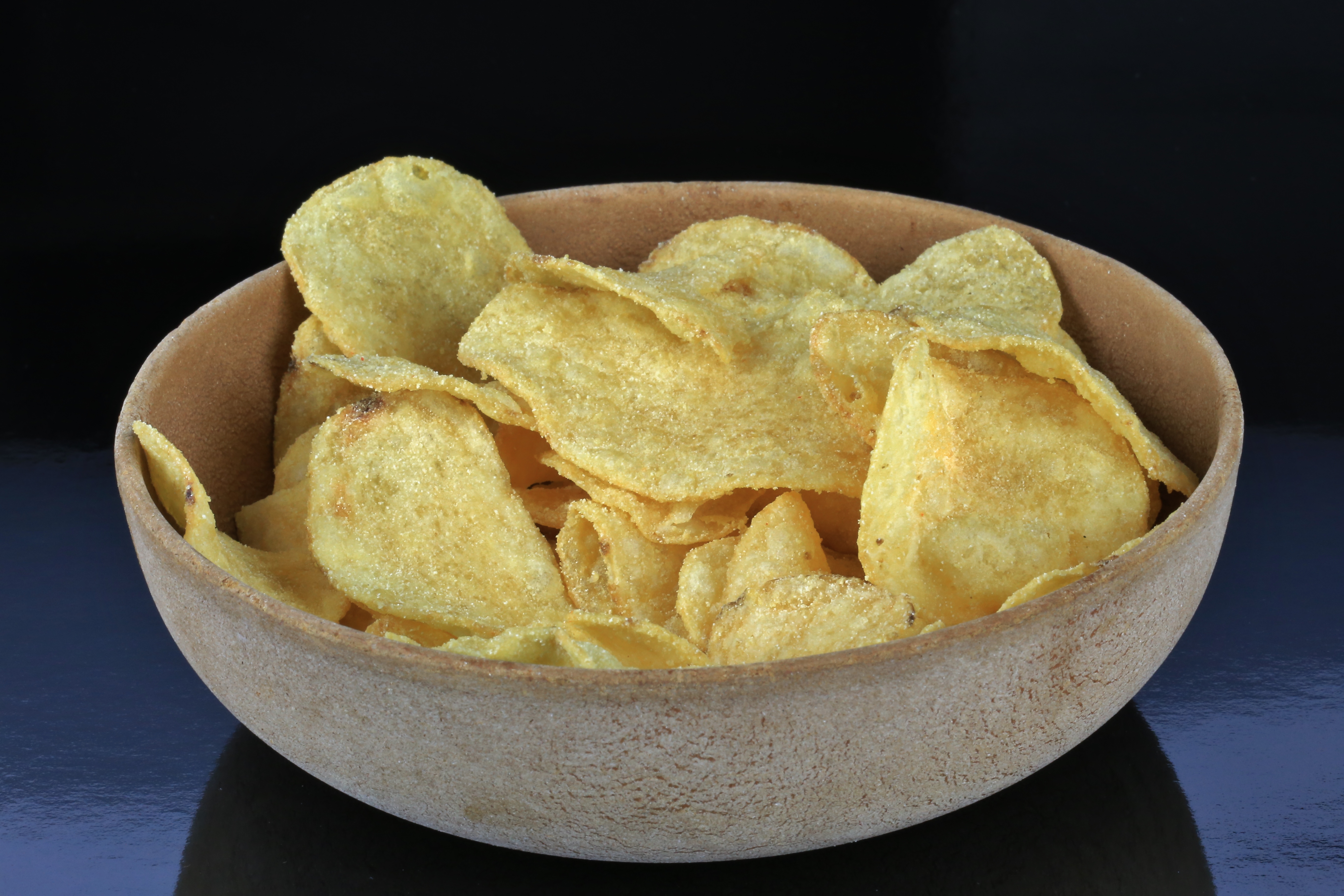 Kettle type potato chips in a wooden bowl