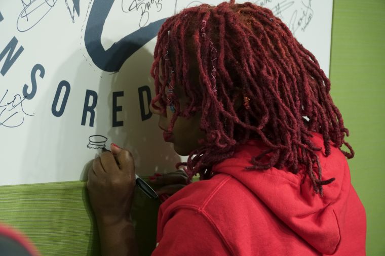 Slutty Vegan Pinky Cole signs Ryan Cameron wall