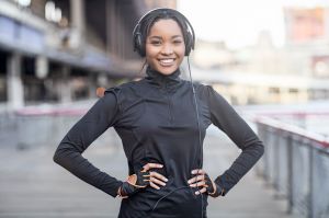 African woman taking a break after running exercise in city