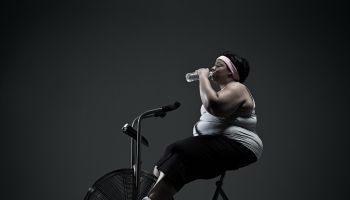 Overweight woman on exercise bike