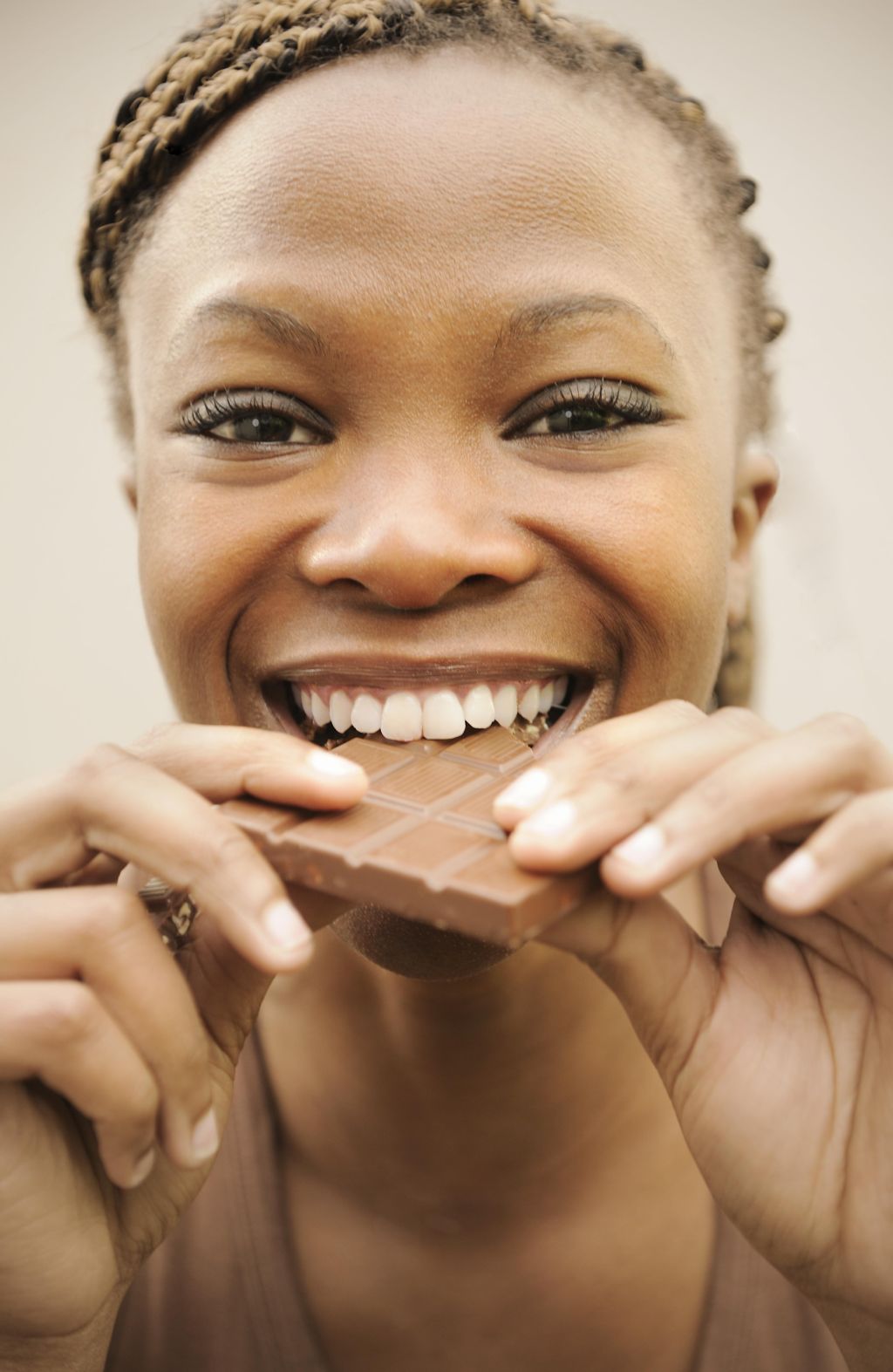 Woman biting into a chocolate slab