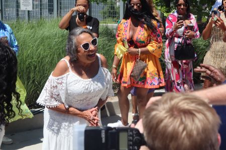 Cathy Hughes taking pictures at the Black Music & Entertainment Walk of Fame
