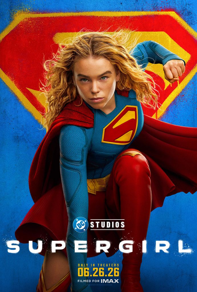 A woman in a red and blue superhero costume with a large "S" emblem on her chest, standing in front of a colorful background with the DC Studios logo.