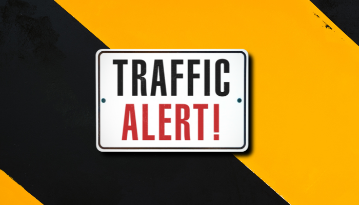 Traffic alert sign on a yellow and black background