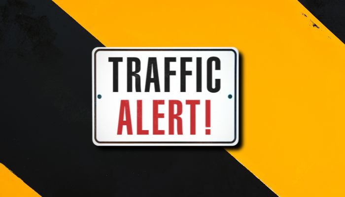 Traffic alert sign on a yellow and black background